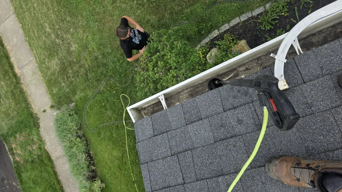 CleanFlow of Ohio cleaning and flow-testing an open gutter on a Dayton-area home